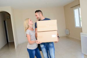 A man and a woman packing up their belonings
