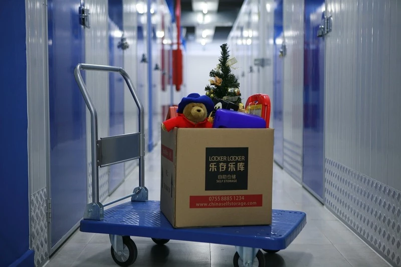 Inside self-storage facility with blue doors and gray walls