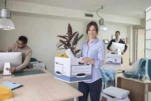 Two man and a woman packing up a office