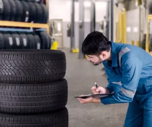 Mechanic checking winter tire for winter tire storage