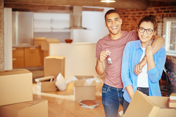 Couple puts stuff in cardboard boxes