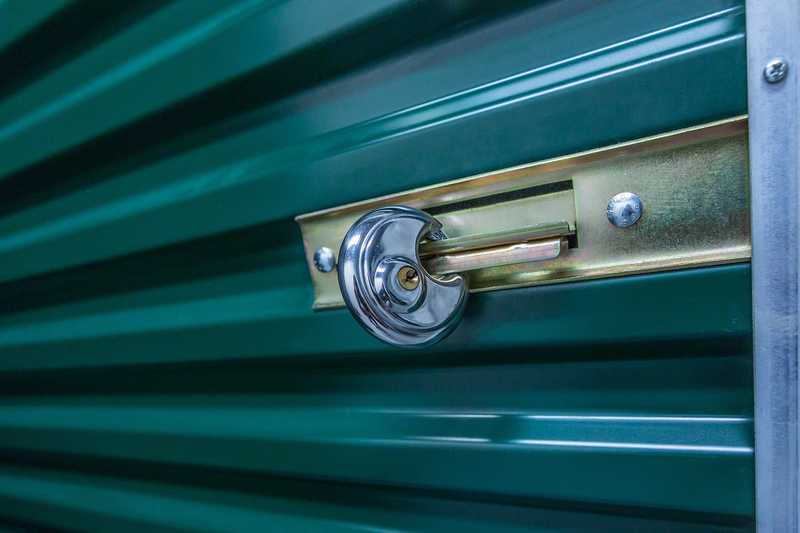 A lock on a green archive storage unit door