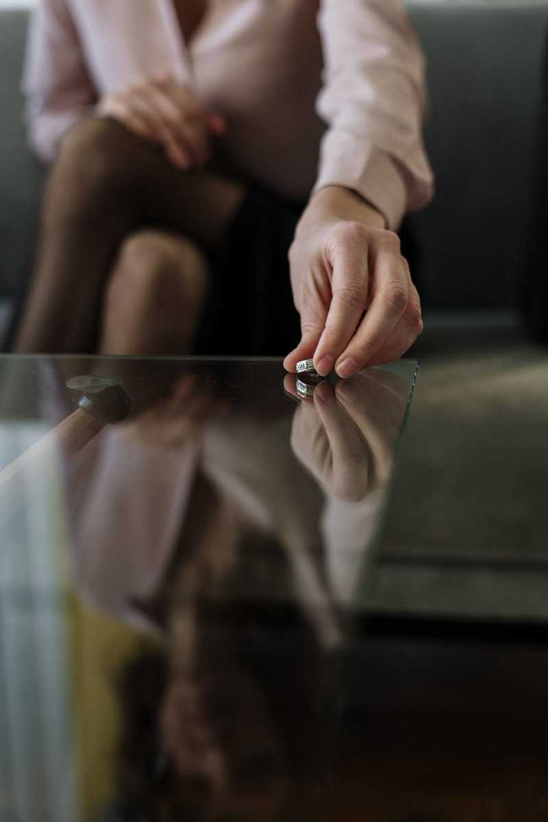 Person puts ring on glass table