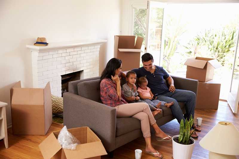 A family sitting on the furniture